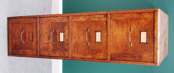 A mid 20th century oak four drawer filing cabinet, 37cm wide x 138cm high.