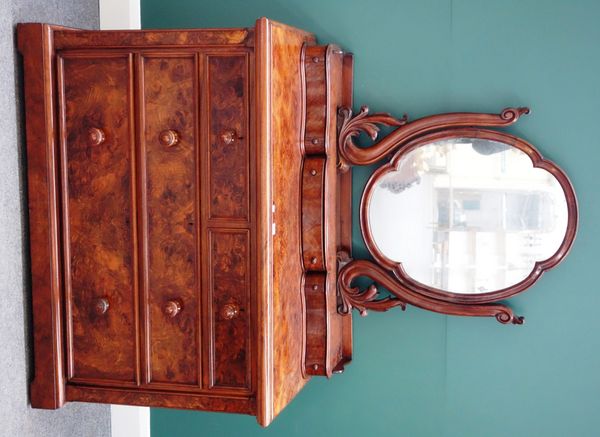 A Victorian figured walnut dressing table, the swing mirror over three shaped jewellery drawers, and two short and two long drawers, on plinth base, 1