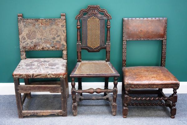 A group of three 17th century chairs, one with brass studded leather upholstery on barley-twist supports, another similar on block supports and a cane