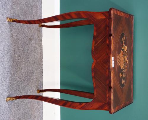 A 19th century inlaid kingwood writing table, the shaped top over single fitted frieze drawer, on gilt metal mounted slender cabriole supports, 54cm w