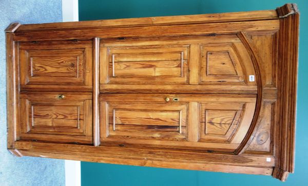 An 18th century pine barrel back corner cupboard, with two pairs of raised panel doors, 95cm wide x 177cm high.