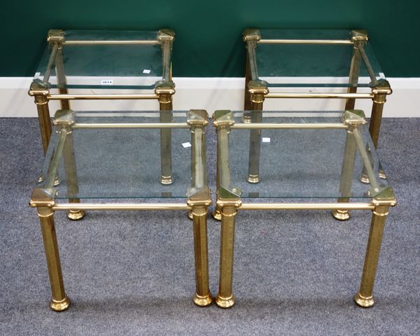 A set of four 20th century lacquered brass and glass square occasional tables on octagonal supports, each 40cm wide. Property from the estates of the