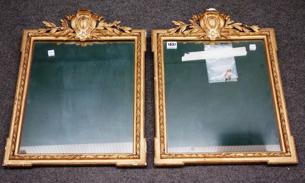 A pair of 19th century gilt framed rectangular wall mirrors, each with cartouche crest and outstepped corners, 42cm wide x 52cm high.Property from the