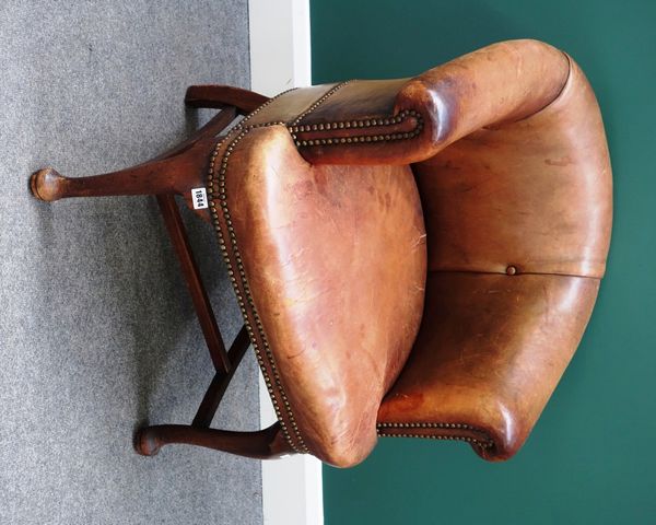 An 18th century style leather upholstered tub back office chair, on mahogany club supports.