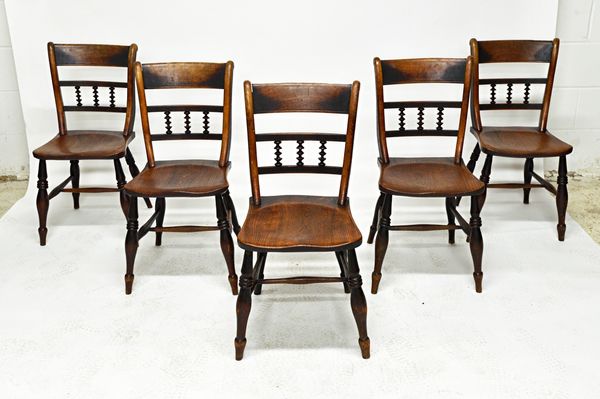 A set of five George III beech and elm kitchen scullery chairs, with triple spindle back over solid seat, on turned supports (5). Illustrated. Footnot