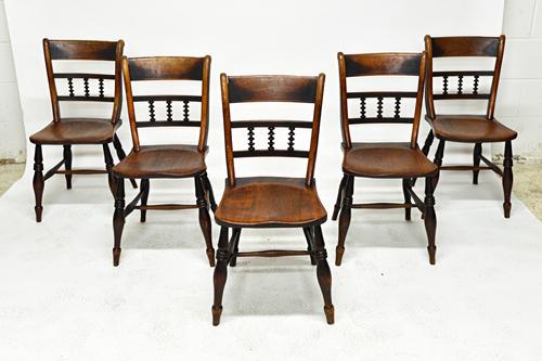 A set of five George III beech and elm kitchen scullery chairs, with triple spindle back over solid seat, on turned supports (5). Illustrated. Footnot