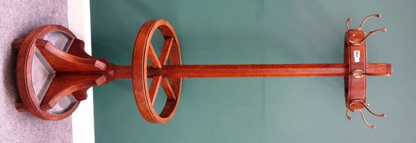 An early 20th century oak coat and umbrella stand, the halo ring mounted with eight coat hooks, on tapering octagonal column and four division stick s