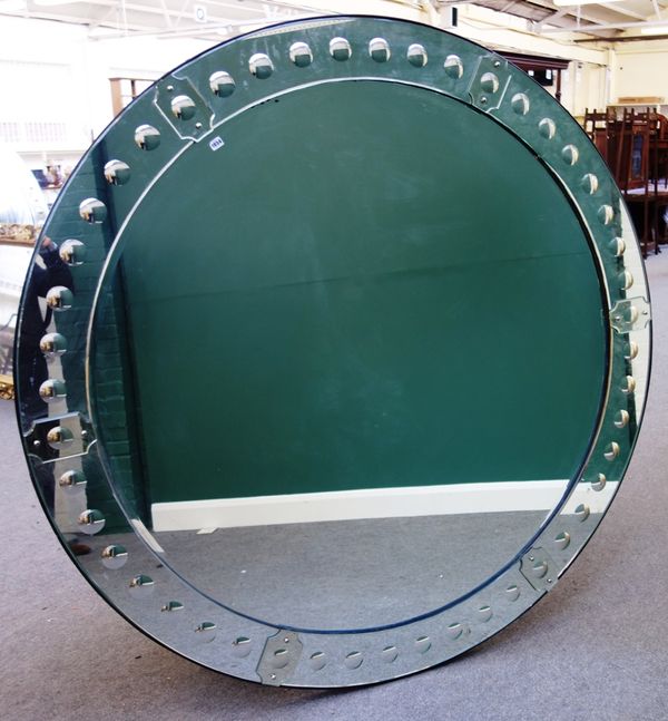 A large 20th century circular wall mirror, the stepped border with repeating convex band, 182cm wide.