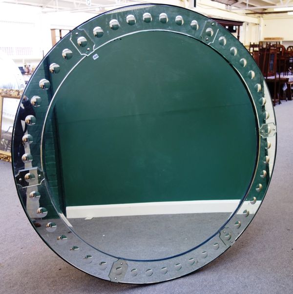 A large 20th century circular wall mirror, the stepped border with repeating convex band, 182cm wide.