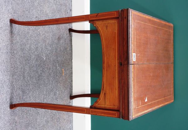 An Edwardian inlaid mahogany writing desk, the fold-out top revealing a fitted interior on splayed square supports, 55cm wide. Property from the estat