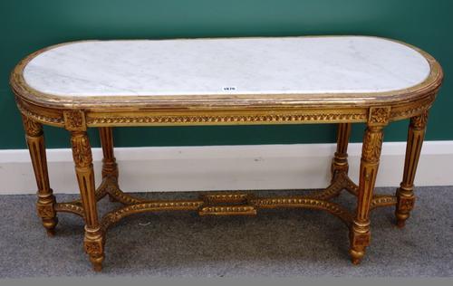 A Louis XVI style giltwood 'D' ended occasional table with inset white marble top, on six legs with under stretchers, 100cm wide. Property from the es