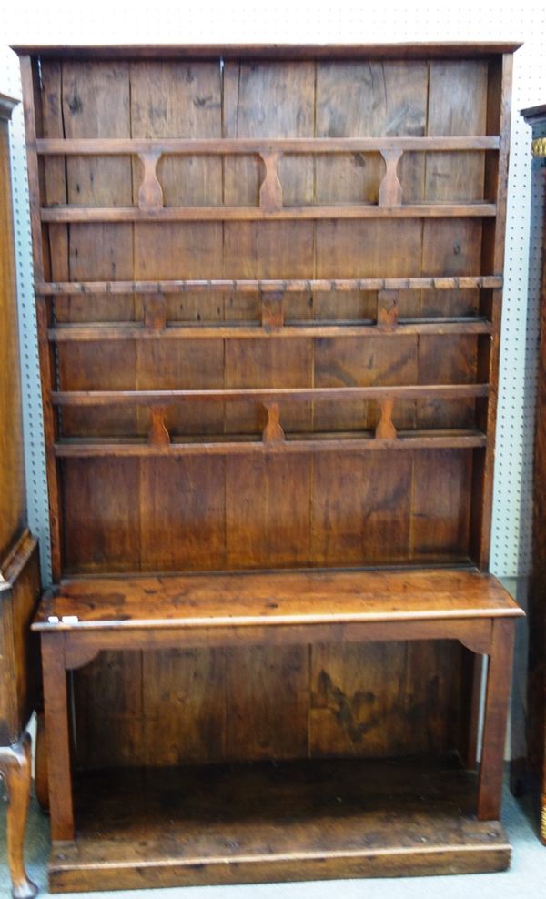 A 19th century French fruitwood and walnut dresser, the three tier enclosed plate rack over a table style base united by platform undertier, 117cm wid