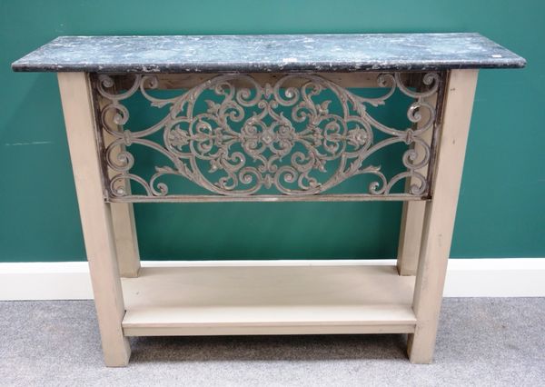 A pair of console tables, each with rectangular black marble top and painted base, with pierced cast iron trellis united by platform under tier, on bl