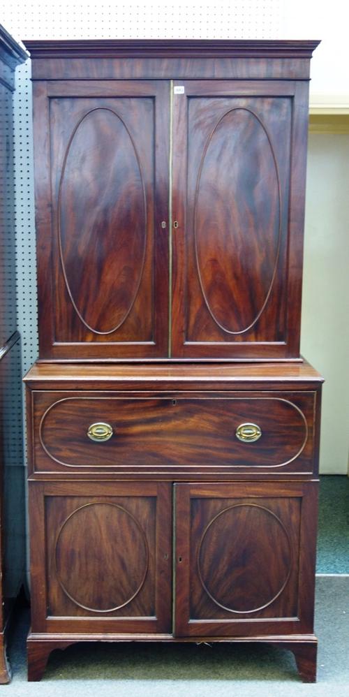A George III mahogany secretaire cupboard, the pair of panel doors over fitted drawer and further pair of cupboards, on bracket feet, 99cm wide x 216c