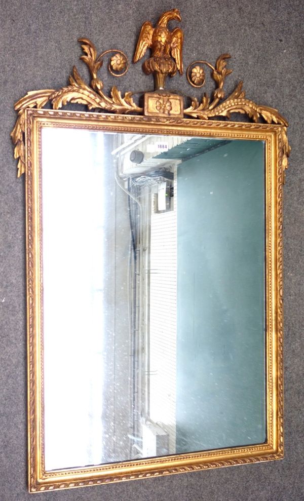 An early 20th century gilt framed rectangular wall mirror, with perched eagle crest, 77cm wide x 120cm high.