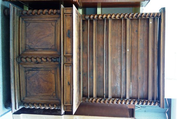 A 19th century French walnut buffet de corps, the enclosed four tier back over pair of drawers and cupboards, flanked by split barleytwist supports, 1