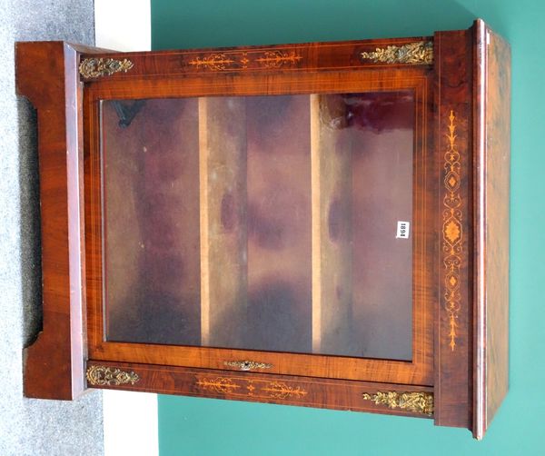 A Victorian gilt metal mounted marquetry inlaid walnut pier cabinet, with single glazed door on plinth base, 78cm wide.