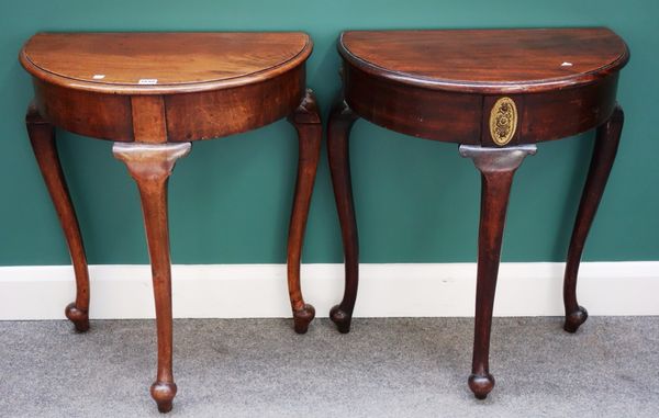 A near pair of 18th century style walnut semi-elliptic consoles, each on three cabriole supports, 60cm wide.Property from the estates of the late Adri