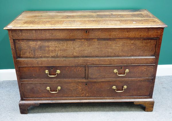 A George III oak mule chest, the lift top over two short and one long drawer, on bracket feet, 125cm wide.