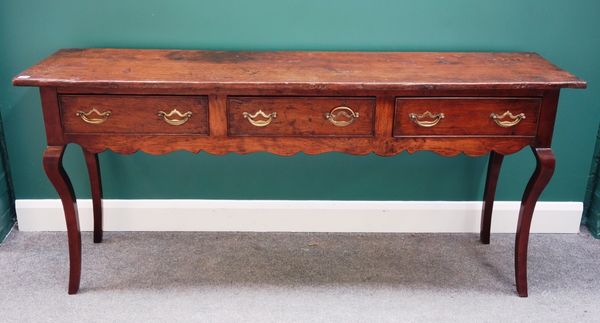 An 18th century style oak dresser base with three drawers over shaped frieze on cabriole supports, 180cm wide. Property from the estates of the late A