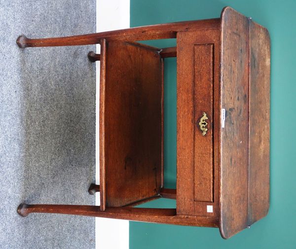 An unusual 18th century oak side table, the lift top revealing a compartmentalised interior over two frieze drawers and side drawer, on club supports,