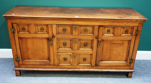 An 18th century fruitwood sideboard, with three central drawers flanked by cupboards, on block supports, 152cm wide.