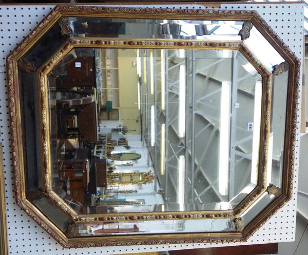 A late 19th century gilt framed and polychrome painted marginal wall mirror of compressed octagonal form, 95cm wide x 111cm high.