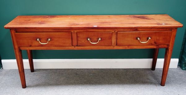 An 18th century fruitwood dresser base, with three frieze drawers, on canted tapering square supports, 181cm wide.