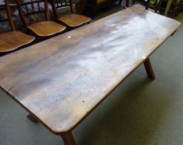 A 19th century elm tavern table of 17th century style, the single slab top on X frame supports, 64cm wide x 183cm long.