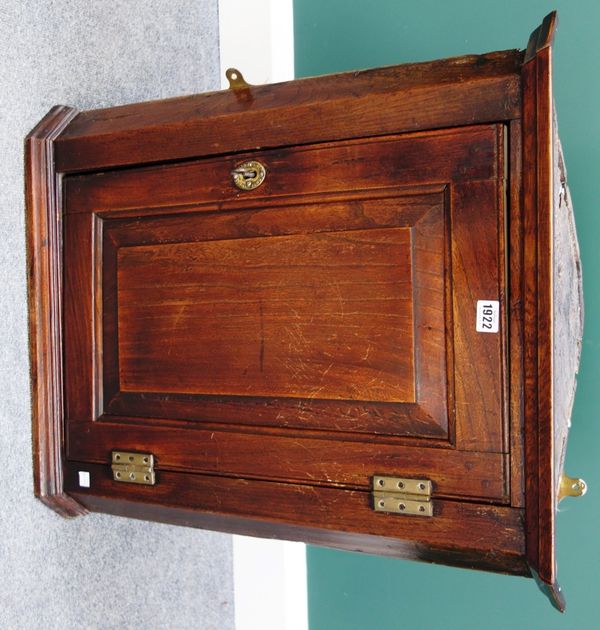 A small 18th century elm hanging corner cupboard, with single panel door, 60cm wide.