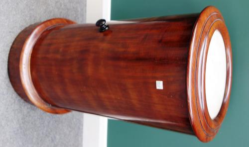 A Victorian mahogany cylindrical pot cupboard, with inset marble top over single door, on plinth base, 38cm wide.
