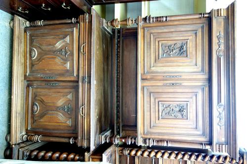 A 19th century French walnut buffet du corps, the pair of carved panel doors over turned gallery, pair of drawers and further pair of cupboards, 140cm