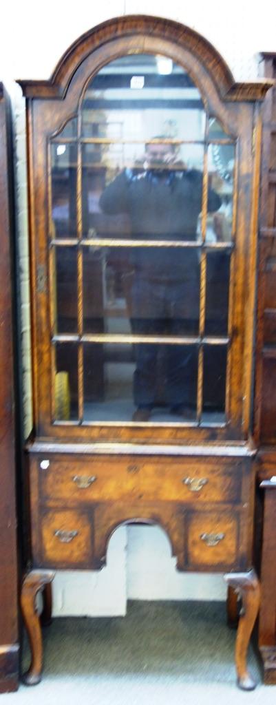 An early 20th century Queen Anne design display cabinet, the arch top over single glazed door and three frieze drawers, on cabriole supports, 71cm wid