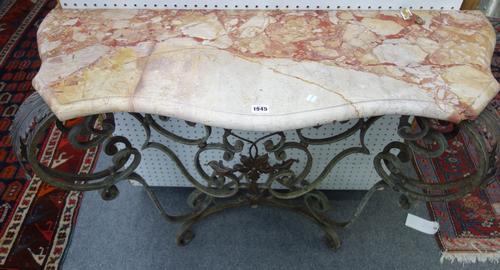 An early 20th century console, the shaped marble top over a blue painted wrought iron base, with twin scroll supports, 111cm wide.