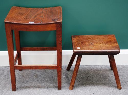 A George III rectangular elm stool with concave seat on tapering square supports together with an oak and elm milking stool on four staked supports, 4