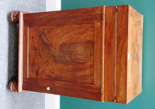 A William IV mahogany Davenport, the lap desk style fold-out top on a pedestal base with panel cupboard, enclosing three drawers on carved bun feet, 5