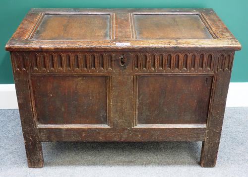 A 17th century oak coffer, with double panel lid and front on stile feet, 84cm wide.