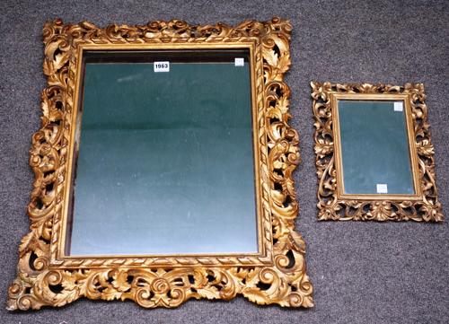 A 19th century Florentine pierced and carved gilt framed wall mirror, 55cm wide x 65cm high, together with a similar smaller, 24cm x 33cm (2).