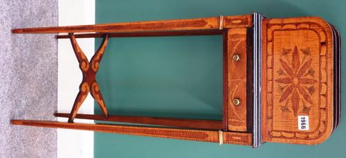 An Edwardian marquetry inlaid satinwood book stand, the three division top over single drawer on tapering square supports, united by X frame stretcher
