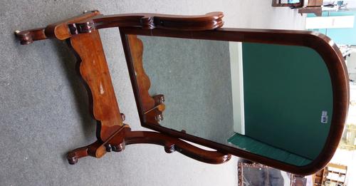 A Victorian mahogany cheval mirror, with arch top and serpentine base, on four downswept supports, 81cm wide.