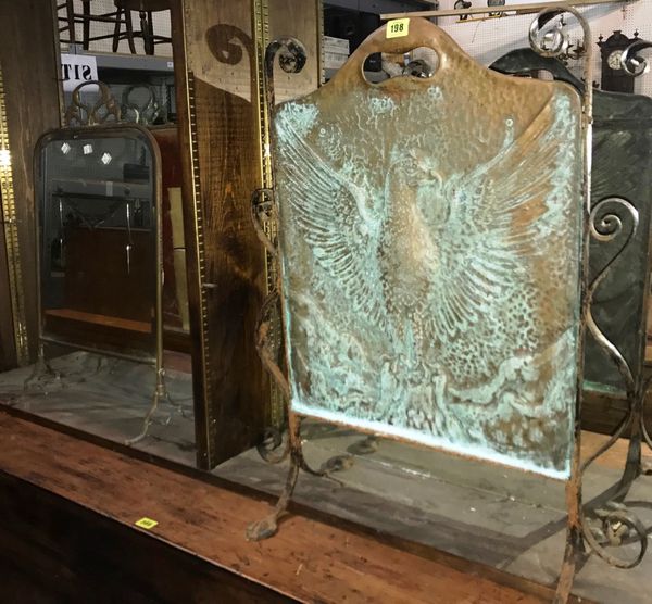A copper fire screen embossed with and eagle and a mirrored fire screen. (2)  DIS