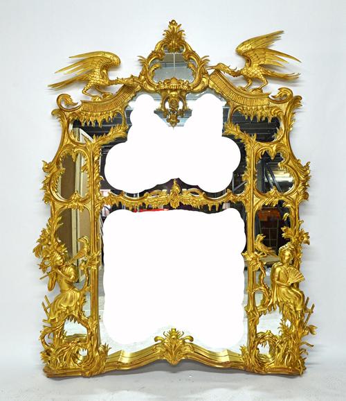 A large Chinese Chippendale design gilt framed marginal wall mirror, with opposing ho-ho bird surmount above a carved and shaped frame mounted with a
