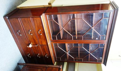A 19th century mahogany bookcase chest, the pair of astragal glazed doors over two short and two long drawers, on plinth base, 152cm wide x 217cm high