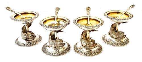 A set of four Victorian silver salts, each with a circular top, decorated with a foliate rim, raised from a fish support and on a similarly decorated