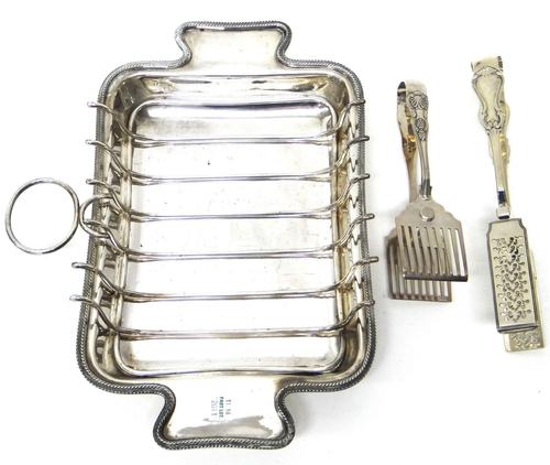 A pair of Victorian silver asparagus serving tongs, London 1843, weight 168 gms and a plated twin handled asparagus serving dish, with a rack (the pla