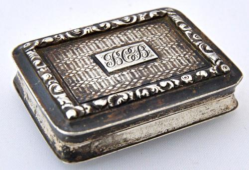 A William IV silver rectangular vinaigrette, with a scroll and floral pierced and engraved grille, the exterior engine turned within moulded borders,