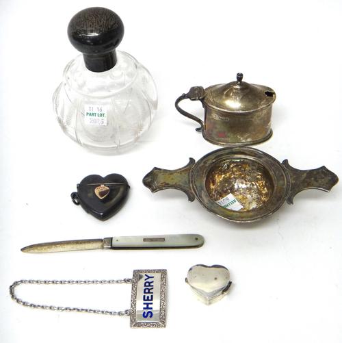 A group of silver and silver mounted wares, comprising; a European twin handled strainer, a silver lidded glass scent bottle, a Victorian silver heart