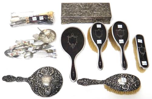 A silver and tortoiseshell mounted four piece dressing set, comprising; a hand mirror, two hairbrushes and one clothes brush, London 1916 and 1917, A