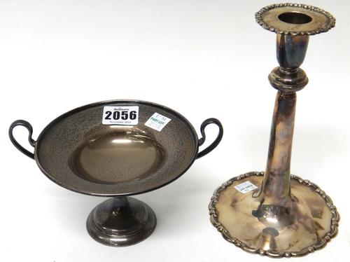 Silver, comprising; a twin handled circular pedestal dish, in a classical style, on a circular foot, Birmingham 1926 and a single candlestick, the rim