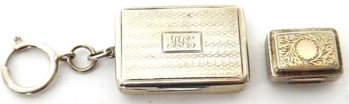 A Victorian silver rectangular vinaigrette, with a scroll pierced and engraved grille, the exterior engine turned, Birmingham probably 1867 and a silv